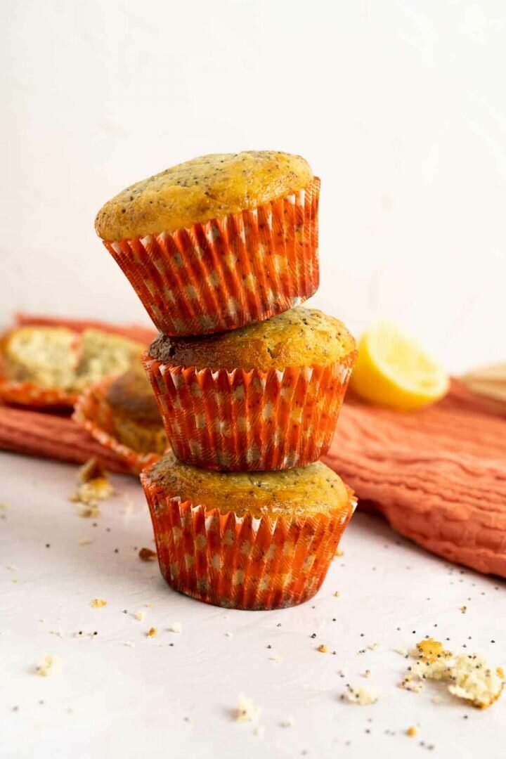 Lemon Poppy Seed Muffins stacked on one another.