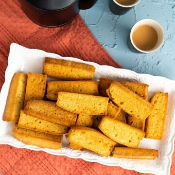 cake rusks on the table with tea kettle and cups with chai.