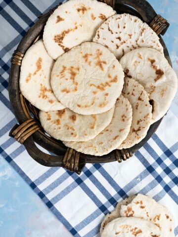 pita bread in a wooden bowl.