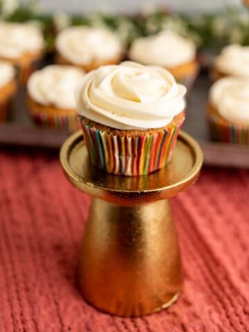 single cupcake on a golden stand.