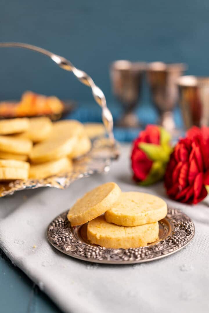 three cookies on a small cute silver plate.