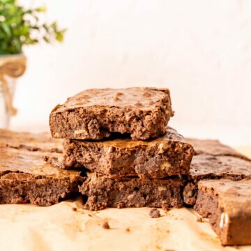 three overlapped condensed milk brownies on the brown paper.