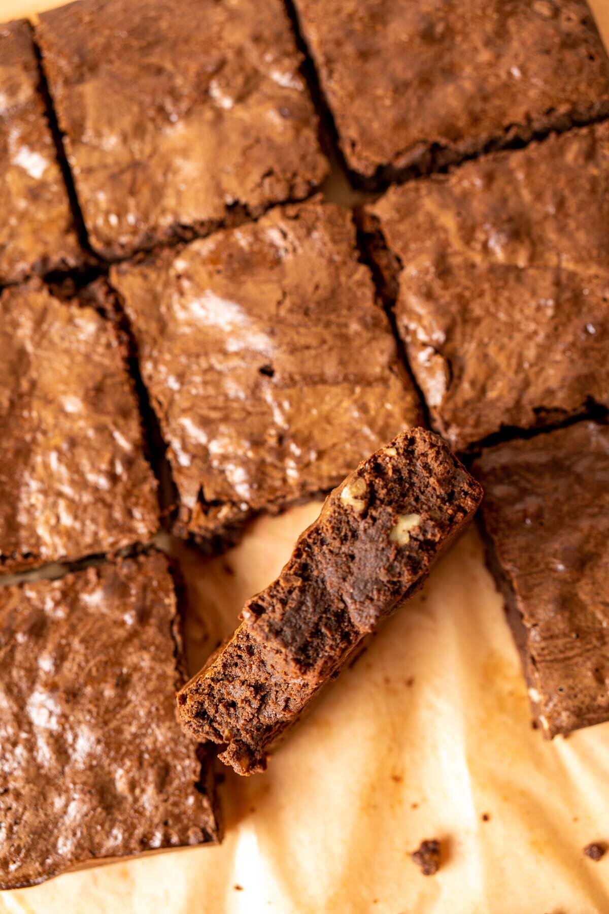 one condensed milk brownie standing among other brownies.