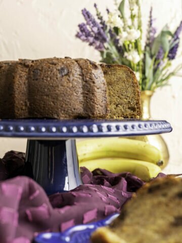 banana chocolate chip cake on blue decorative cake plate.