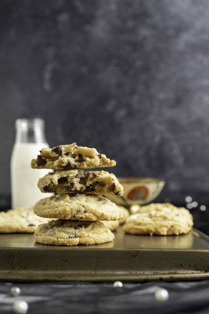 four chocolate chip cookies without brown sugar overlapped on each other.