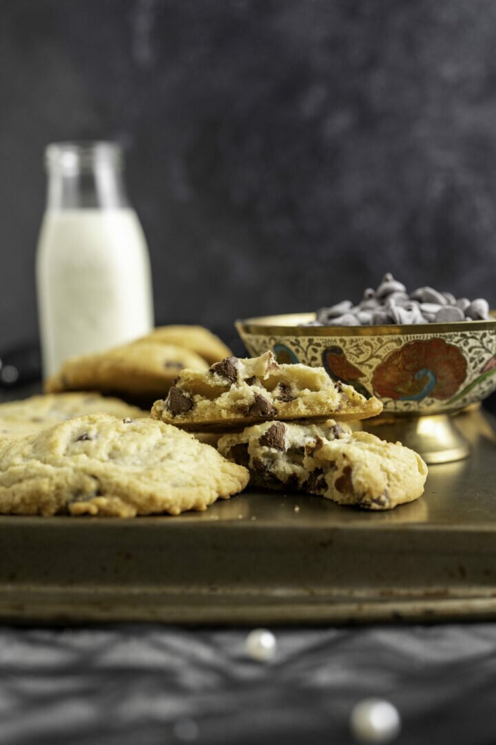 one chocolate chip cookie cut in half showing the texture inside.