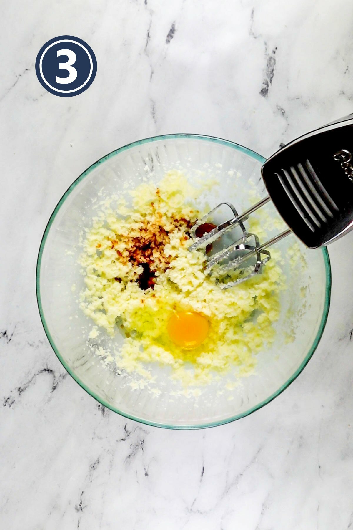 adding the egg and vanilla extract in the creamed butter and sugar mixture.